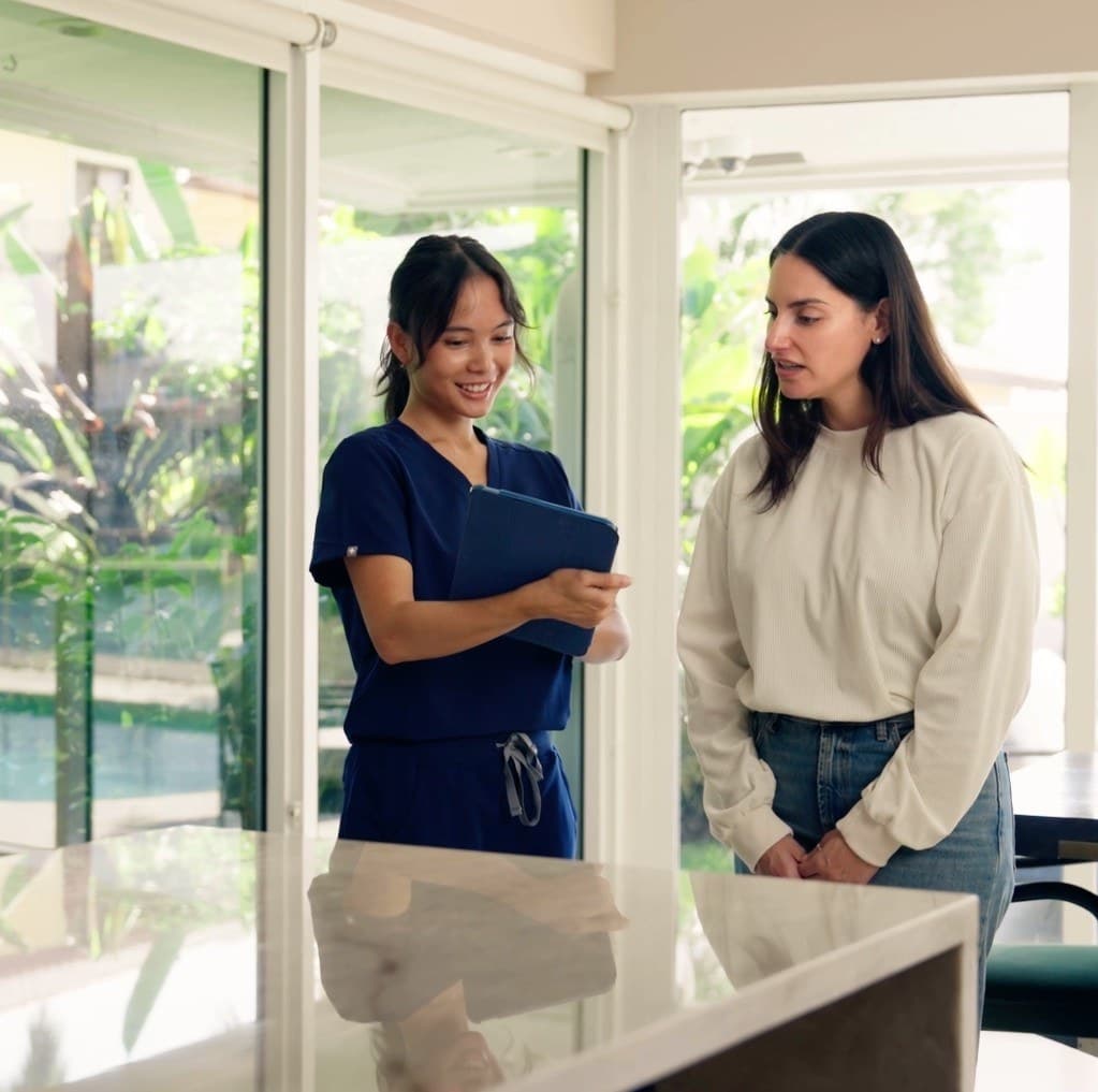 A TestWell nurse walking a patient through her results on a tablet
